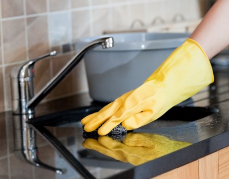 Cleaner preparing equipment while following a health and safety routine